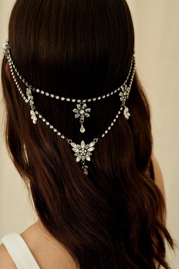 A Gatsby-inspired bridal hair accessory made with multiple strands of antique crystal chain and wired with freshwater pearls 