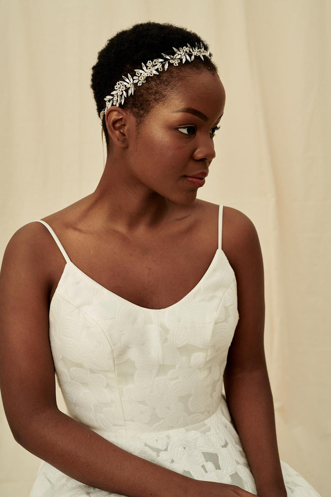 A unique and delicate bridal halo featuring marquise crystals and cream beading on silver wire