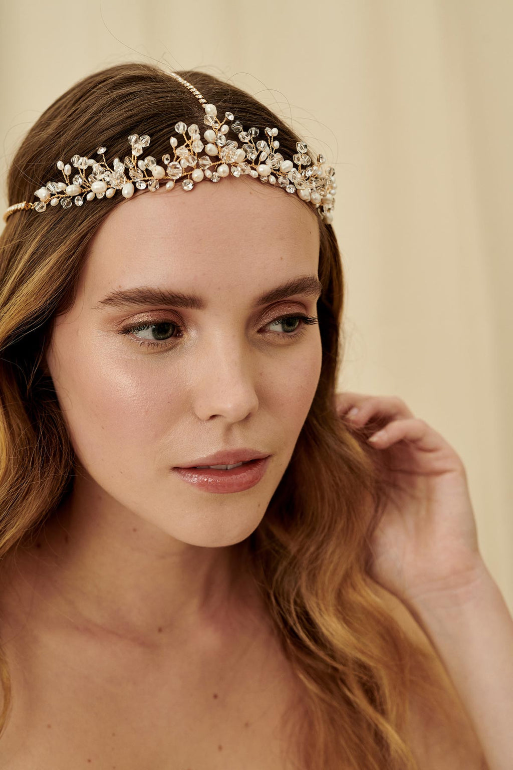A vintage-inspired three strand bridal headpiece made with pearls and Swarovski crystals