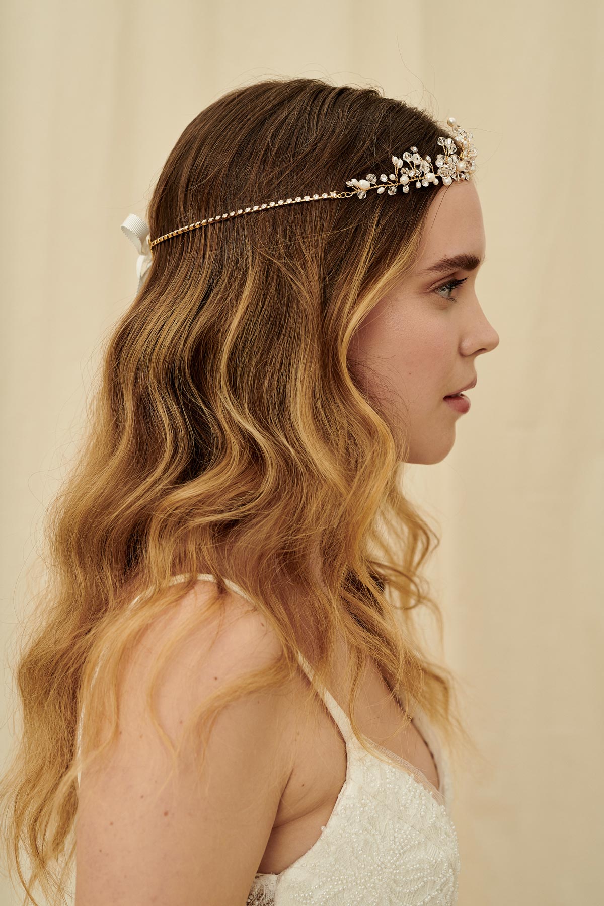 A vintage-inspired three strand bridal headpiece made with pearls and Swarovski crystals