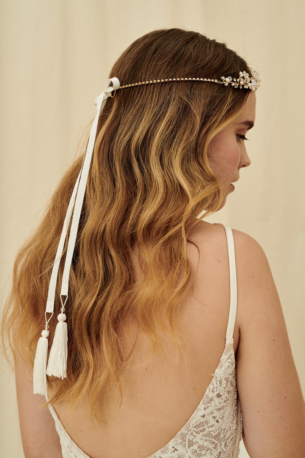 A vintage-inspired three strand bridal headpiece made with pearls and Swarovski crystals