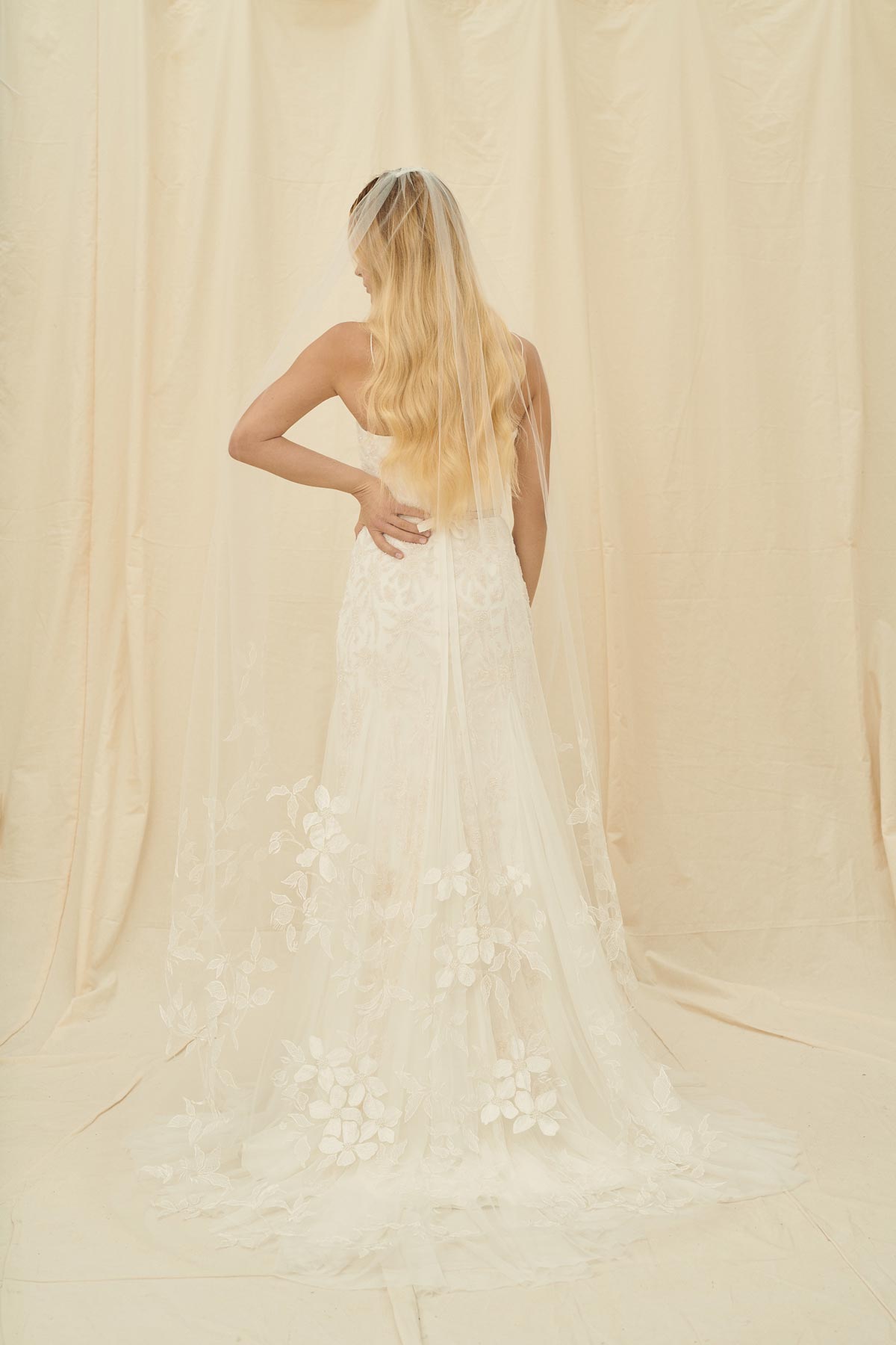 A simple bridal veil with floral embroidery on the bottom half of the soft tulle
