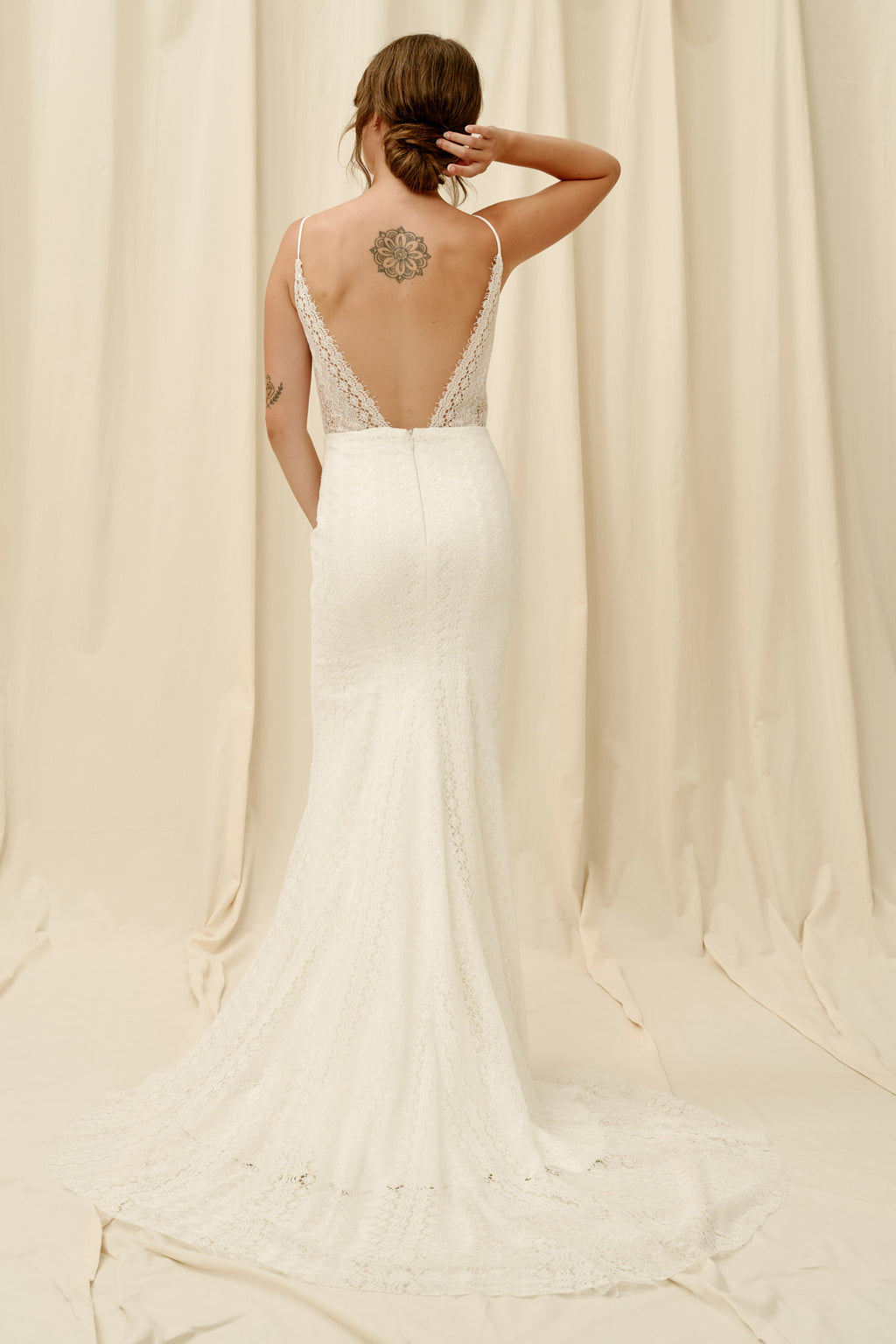 Fitted lace wedding dress with spaghetti straps and a long train