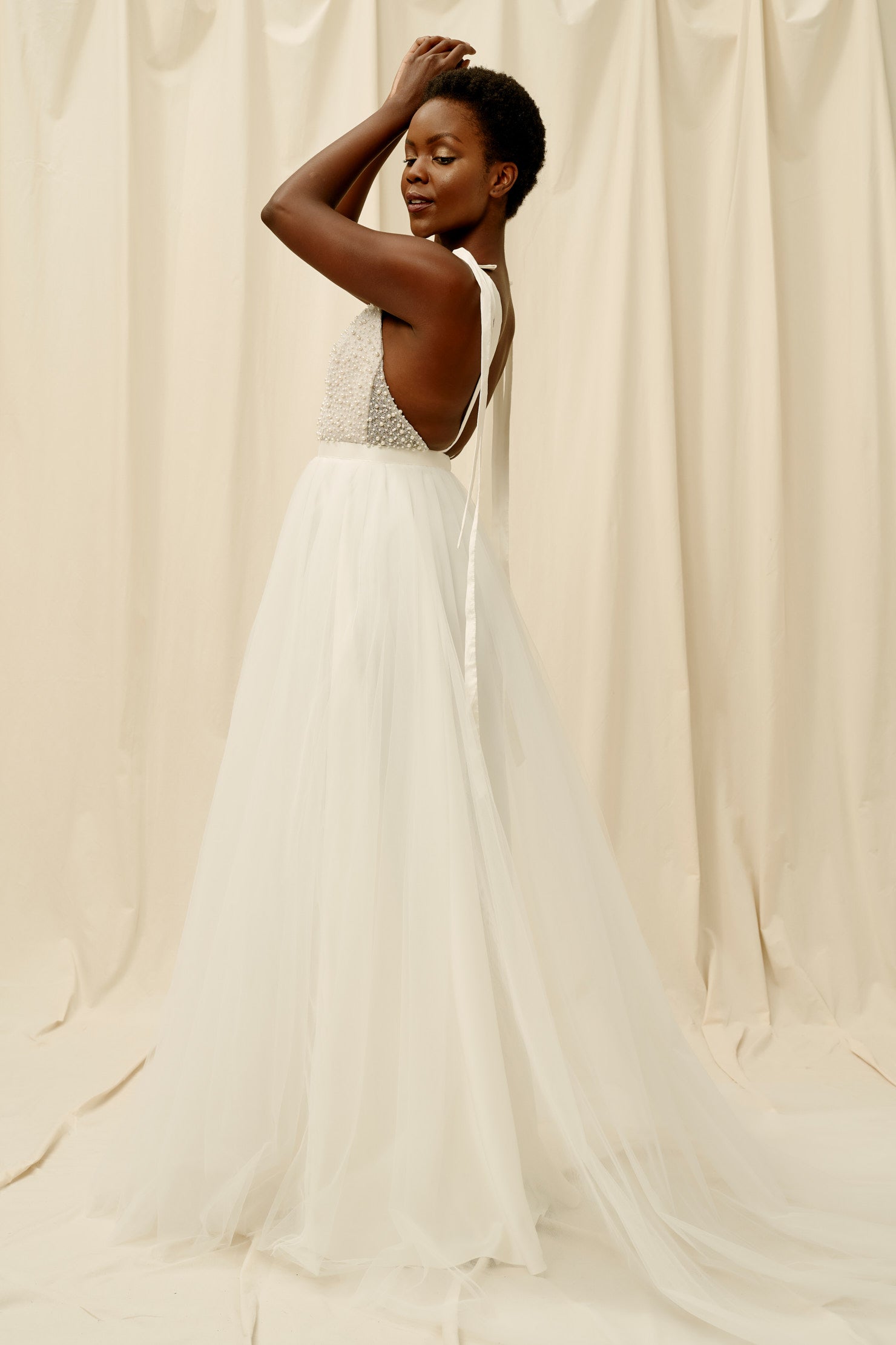 Backless wedding dress with a soft tulle skirt and shoulder tie straps