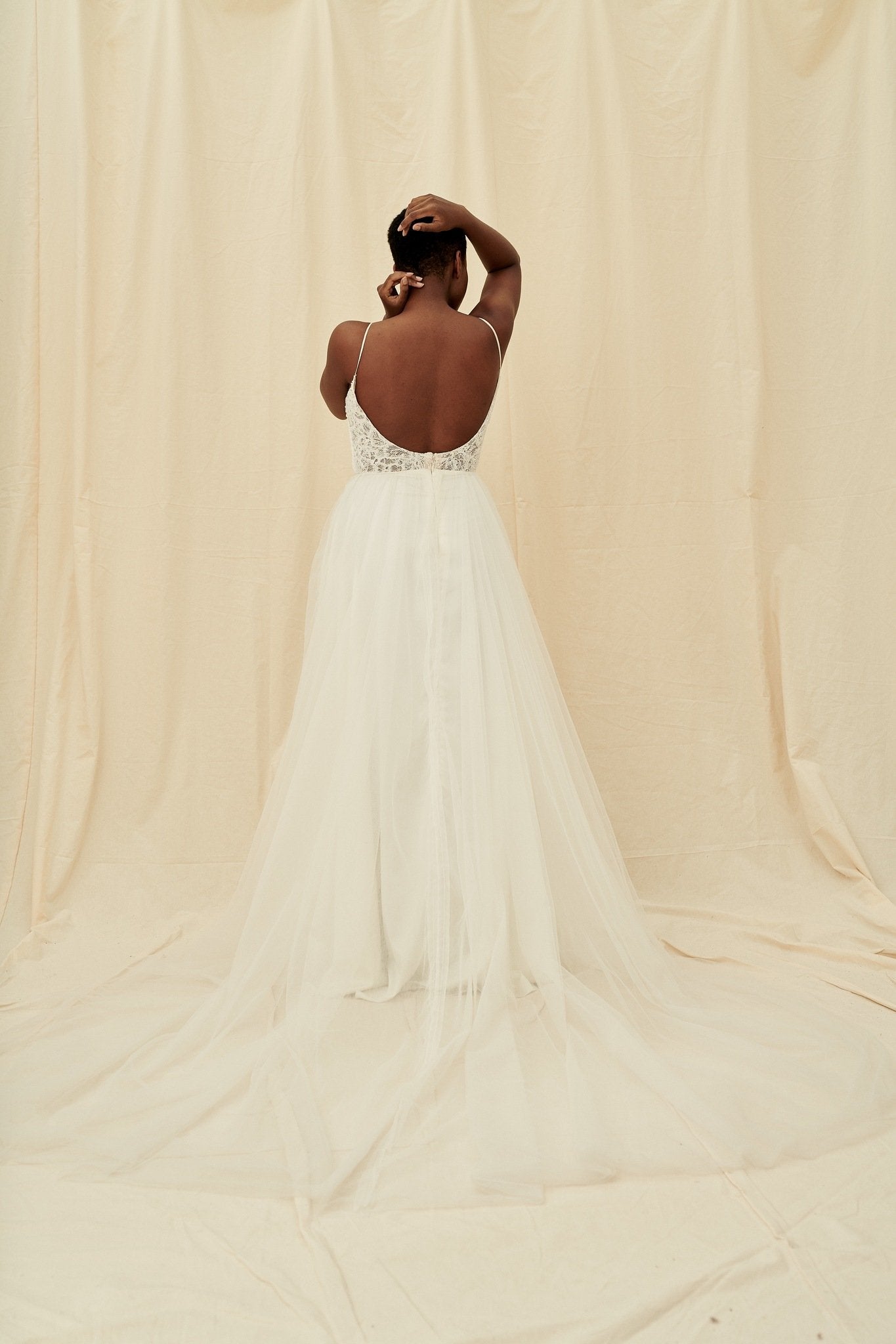 A scoop back dress with a plunging beaded bodice and a princess tulle skirt by Truvelle