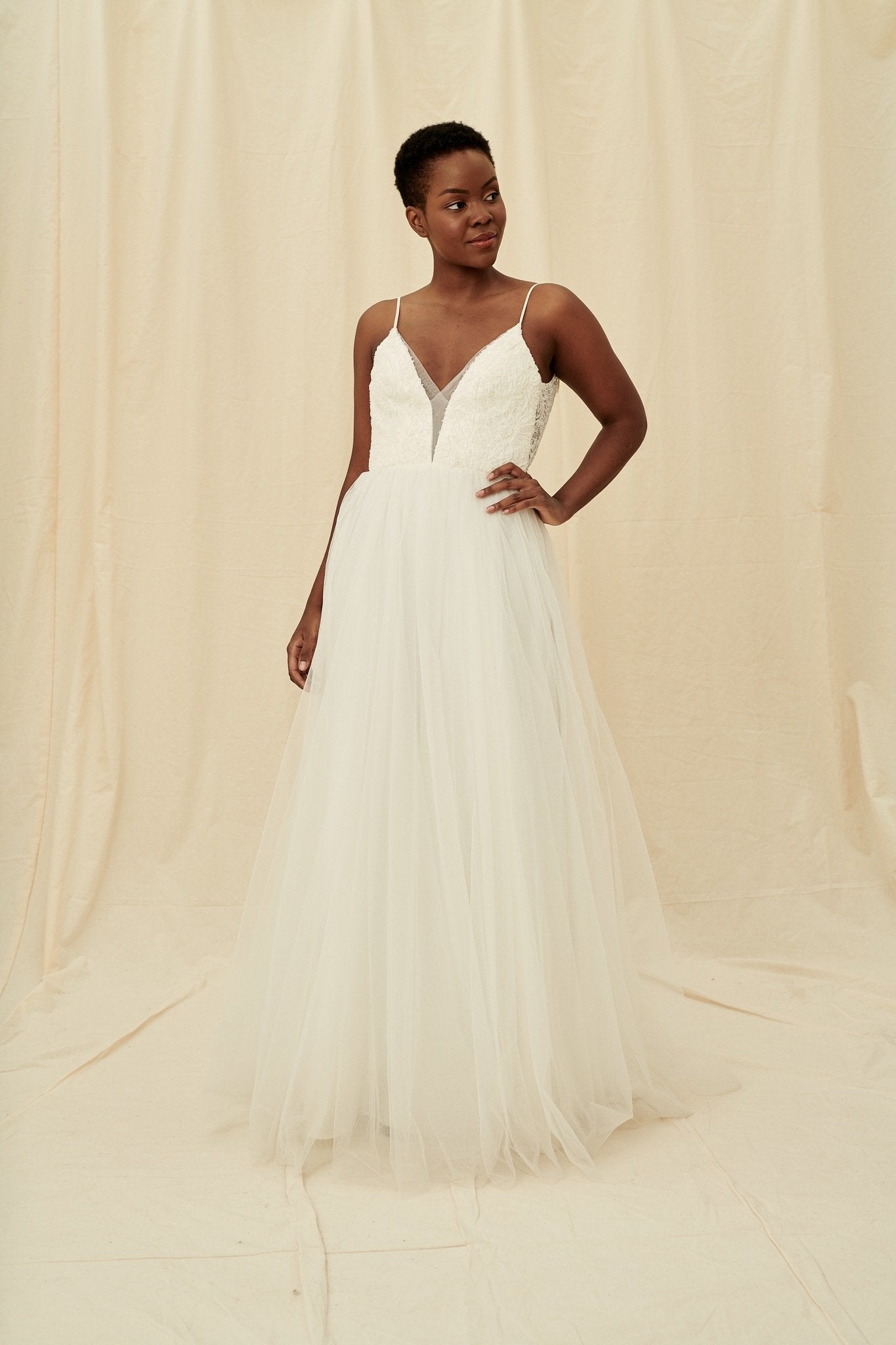 A scoop back dress with a plunging beaded bodice and a princess tulle skirt