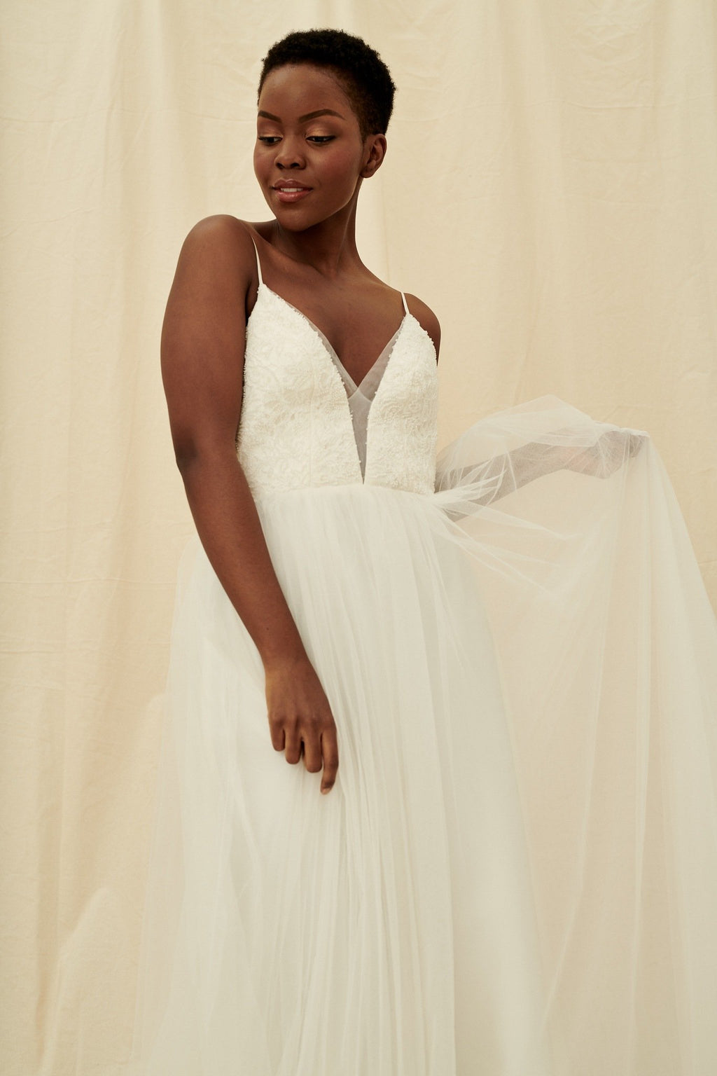 A scoop back dress with a plunging beaded bodice and a princess tulle skirt by Truvelle