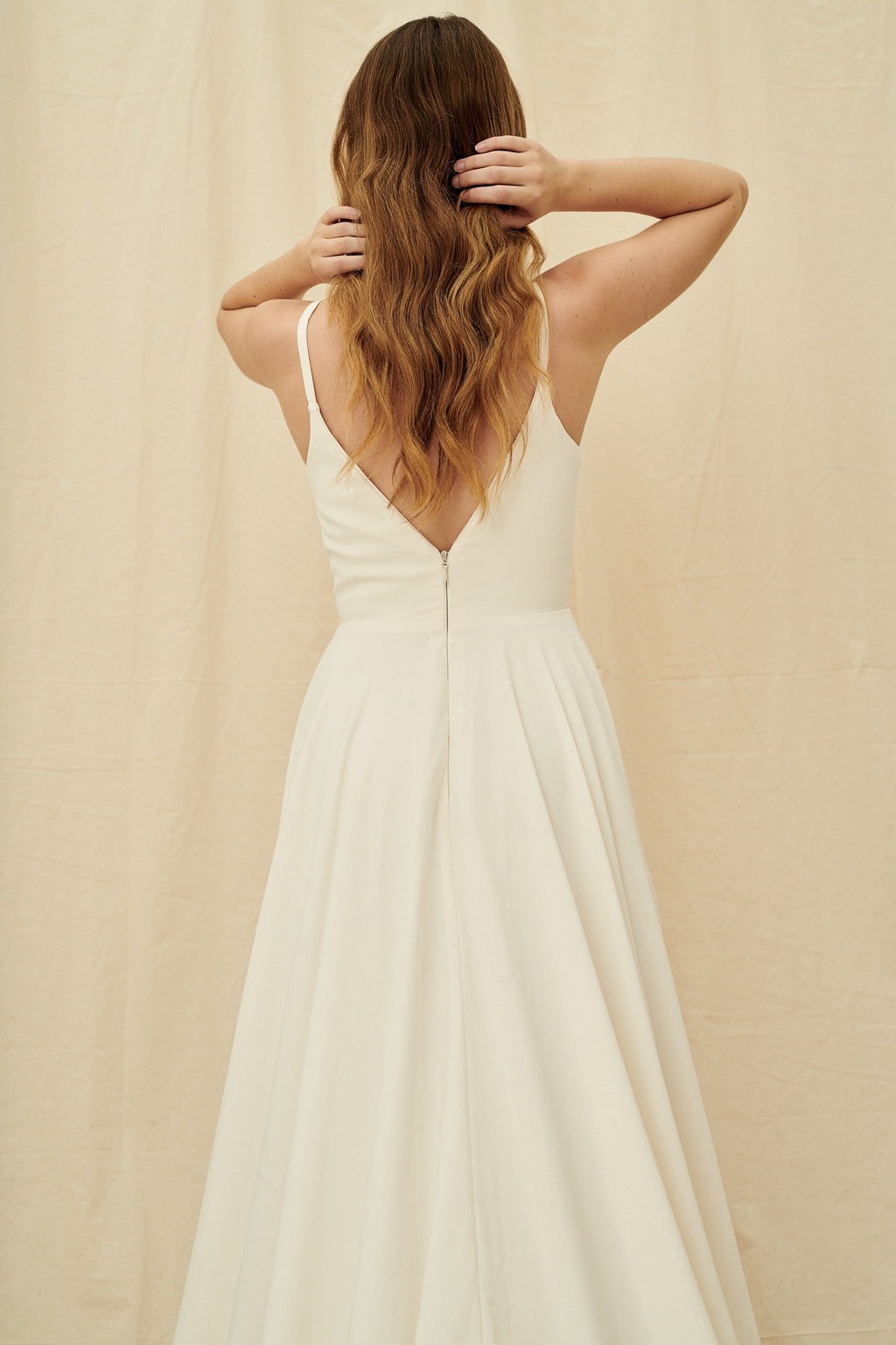 Simple crepe wedding dress with an extra long train and pockets