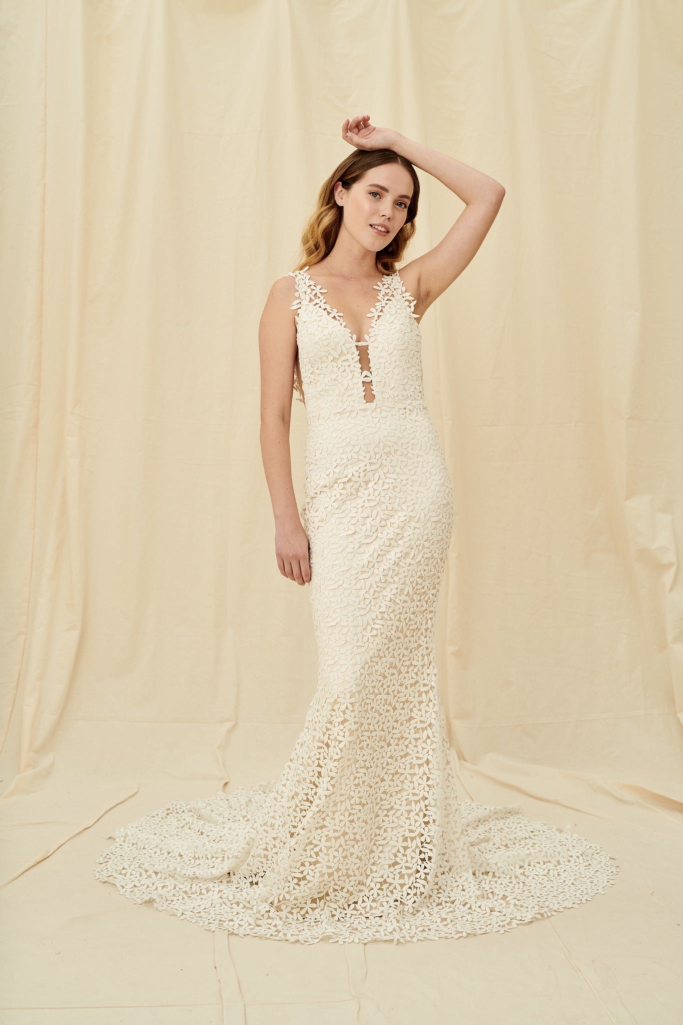 Mermaid wedding dress with all-over flower lace, a dramatic train, and a low back