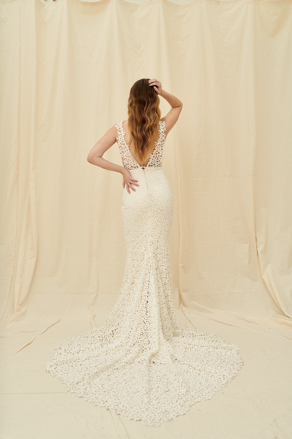 Mermaid wedding dress with all-over tiny flower lace, a dramatic train, and a low back