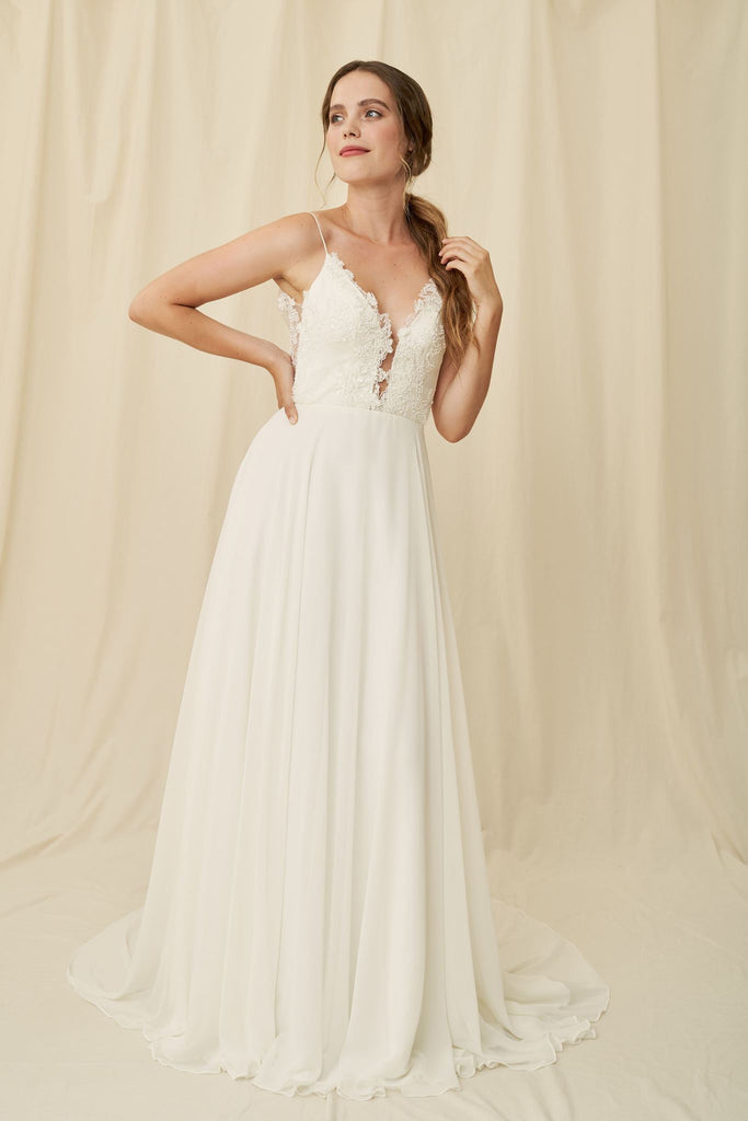 Flowy wedding dress with a low-cut lace bodice and sheer scoopback