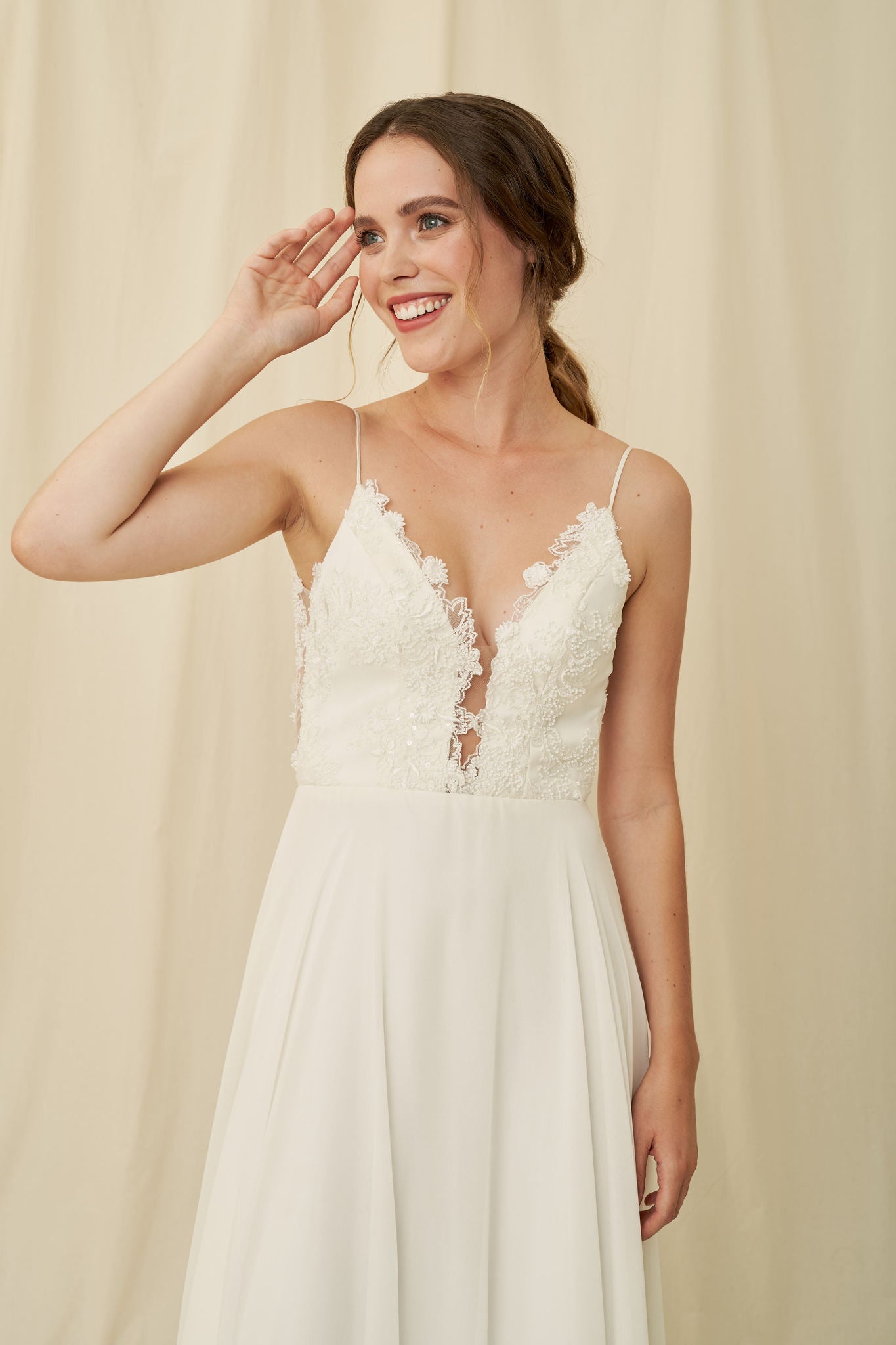 Flowy wedding dress with a low-cut lace bodice and sheer scoopback